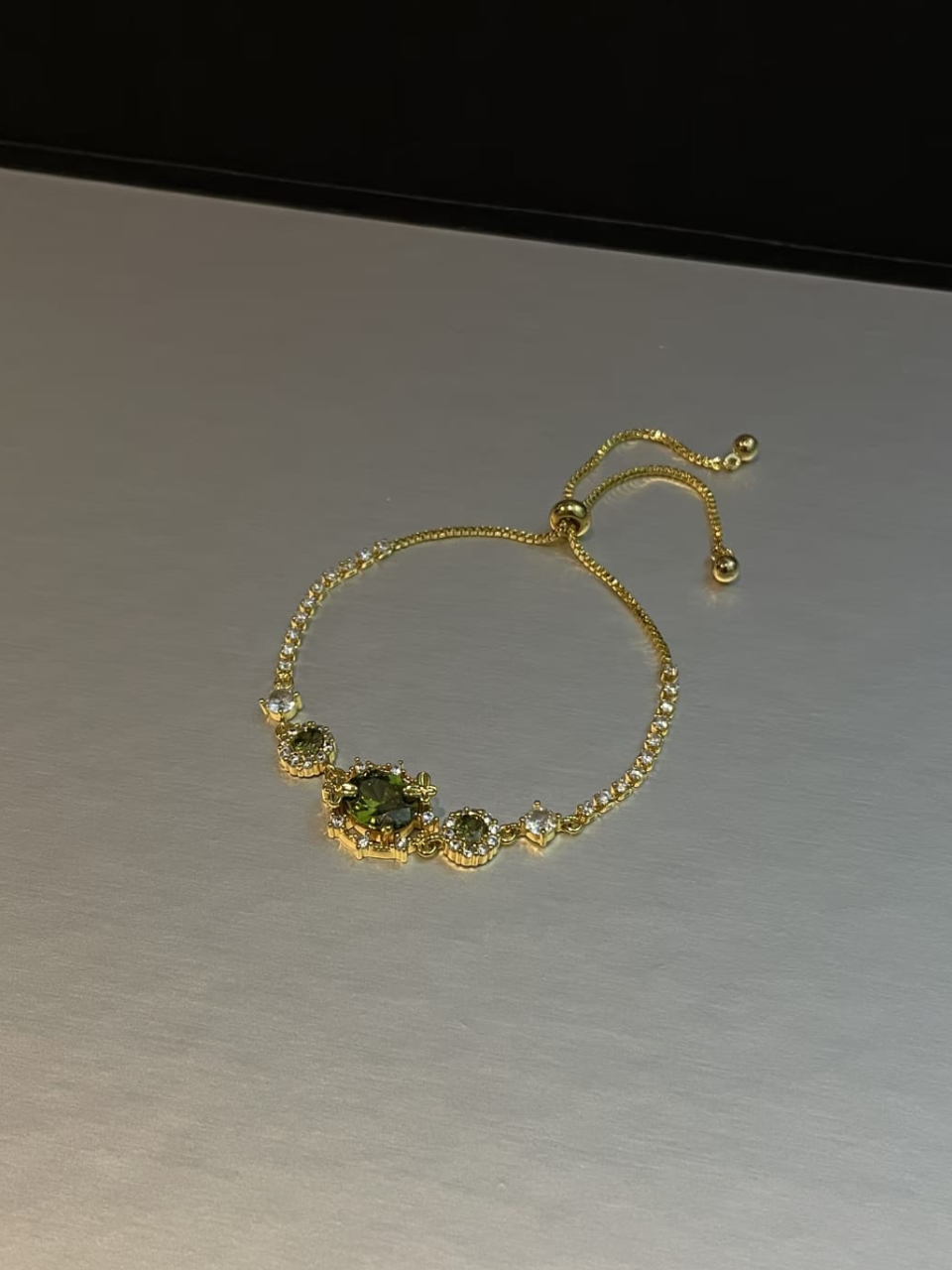 Gold Tone Emerald Accent Slider Bracelet